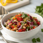 Dense bean salad meal prep with printed recipe card