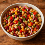 Serving Italian cold bean salad dense with fresh parsley and lemon garnish