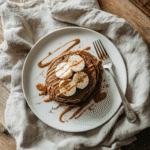 chocolate peanut butter chickpea pancakes on plate with toppings