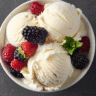 Cottage cheese ice cream served in a white bowl with berries