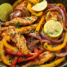 Chicken fajita marinade cooked in cast iron with peppers and limes