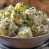 Creamy gluten free potato salad recipe in white bowl