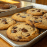 Tray of espresso chocolate chip cookies with golden edges and gooey chocolate chips.
