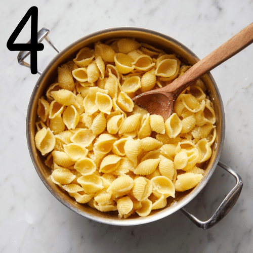 Pasta cooking in creamy chicken broth for Marry Me Chicken Soup Recipe until tender and al dente.