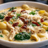 Marry Me Chicken Soup Recipe with chicken, pasta, sun-dried tomatoes, and Parmesan in a rustic bowl