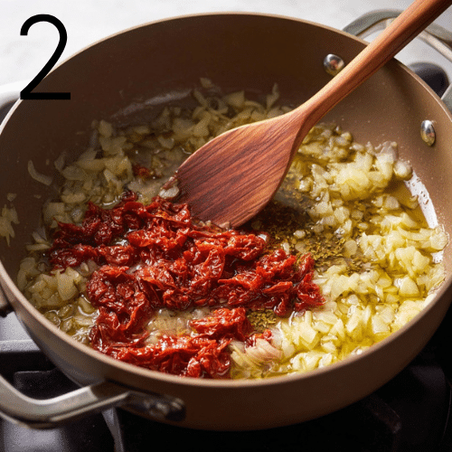 Cooking step showing tomato paste and chopped sun-dried tomatoes being stirred in a pot for Marry Me Chicken Soup.