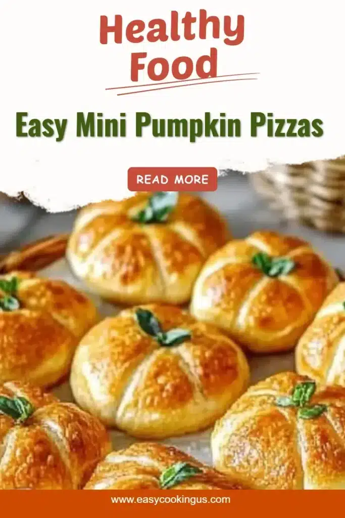 Easy mini pumpkin pizzas topped with cheese and herbs on a baking sheet.