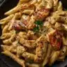 Delicious plate of Cajun Chicken Pasta with spices and chicken over pasta.