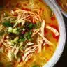 Bowl of Classic Ginger Garlic Chicken Noodle Soup featuring chicken, ginger, and garlic.