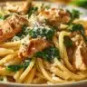 Creamy garlic parmesan chicken pasta dish topped with herbs