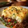 Easy Shepherd's Pie casserole with meat and vegetables topped with creamy mashed potatoes.