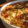 French Onion Chicken Orzo Casserole dish topped with melted cheese and herbs