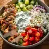 Delicious Greek Chicken Bowl with veggies and tzatziki sauce