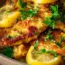 Quick Lemon Chicken dish garnished with fresh herbs and lemon slices.