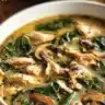 Creamy rotisserie chicken mushroom soup in a bowl garnished with herbs