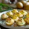 Plate of deviled potatoes garnished with herbs and spices