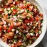 Bowl of fresh Pico de Gallo with tomatoes, onions, cilantro, and lime.