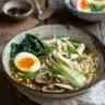 A bowl of delicious homemade ramen topped with green onions and soft-boiled egg.