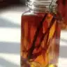 Homemade vanilla extract in a glass bottle with vanilla beans