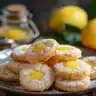 Lemon curd cookies fresh out of the oven, topped with zest and powdered sugar.