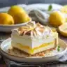 Slice of lemon meringue cheesecake with lemon zest and meringue topping