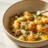 Delicious Pesto Sausage Gnocchi Bake served in a ceramic dish