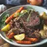 Delicious stovetop pot roast served with vegetables on a rustic table