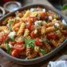 Delicious Tomato Goat Cheese Pasta topped with fresh herbs and spices.