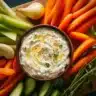 Creamy vegetable dip served with a variety of fresh vegetables for dipping.