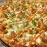 Delicious Buffalo Chicken Pizza topped with spicy sauce and cheese.