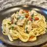 Plate of creamy Cajun garlic butter chicken pasta garnished with herbs