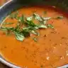 Bowl of easy homemade tomato soup garnished with fresh basil