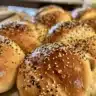 Freshly baked homemade bagels on a cooling rack