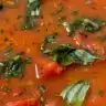 Bowl of homemade tomato soup garnished with fresh herbs