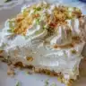 Delicious key lime pie bars topped with whipped cream and lime zest.