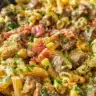 One-skillet spicy ranch chicken and steak pasta dish with vibrant colors.