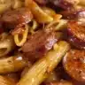 Smoky Honey Garlic Sausage Penne dish garnished with herbs