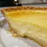 Delicious slice of homemade Buttermilk Pie with a golden crust and creamy filling