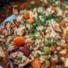 Bowl of hearty turkey soup with rice and kidney beans
