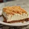 No-Bake Carrot Cheesecake topped with nuts and a slice of carrot