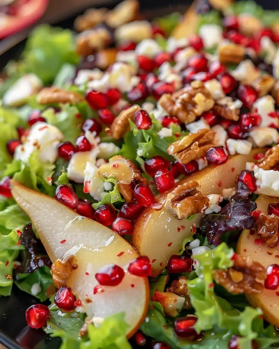 Fresh Pear and Pomegranate Salad with greens and dressing