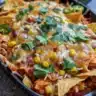 Delicious Chicken Enchilada Skillet topped with cheese and fresh herbs