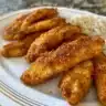 Crispy baked chicken tenders served with dipping sauce