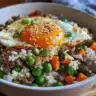 Plate of easy beef fried rice with eggs, garnished and ready to serve.