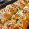 Homemade pull-apart bread with herbed cream cheese served warm.