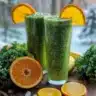 Kale Orange Banana Smoothie in a glass with a straw, vibrant and healthy