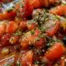 Homemade marinara dipping sauce in a bowl with fresh herbs