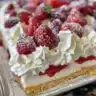 No Bake Berry Chantilly Cake topped with fresh berries and whipped cream