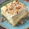 Delicious slice of Quick Italian Cream Cake with creamy frosting and nuts