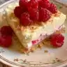 Delicious raspberry lemon cheesecake bars on a plate.
